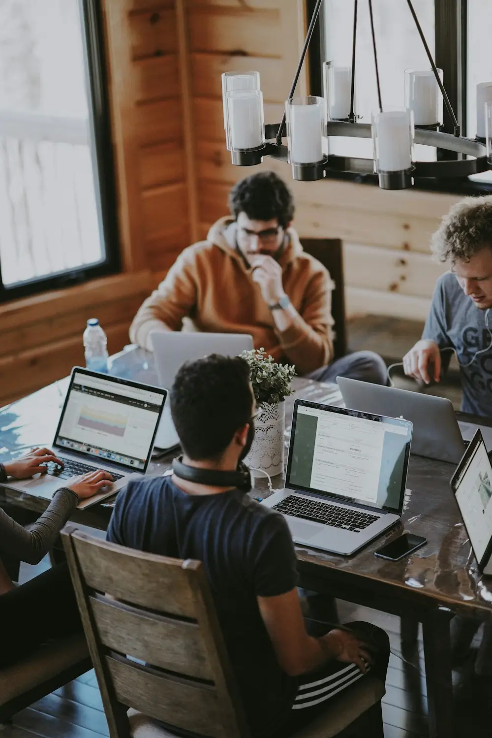 Developers working together on laptops at a shared table